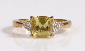 A 9 carat gold diamond and yellow sapphire ring, the head set with a claw mounted cushion cut yellow