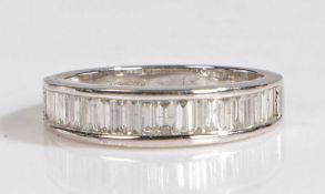 A 18 carat white gold and diamond half eternity ring, the ring set with a row of baguette cut