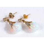 A pair of  yellow gold and white opal pendant earrings the opal pear shaped drops are suspended from