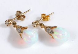 A pair of  yellow gold and white opal pendant earrings the opal pear shaped drops are suspended from