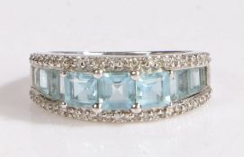 A modern 9 carat white gold and aquamarine ring , set with three square cut aquamarines at the