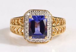 A 18 carat gold AAA tanzanite and diamond ring, the head set with a claw mounted antique cut AAA