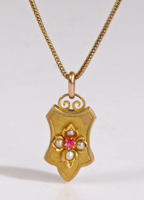 An antique locket formed of an elegant plaque with raised floral motif, set with pearls and a red - Image 2 of 2