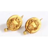 A pair of antique earrings each formed of a plaque featuring a floral motif, the plaque framed