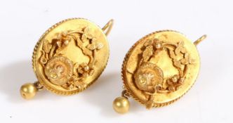 A pair of antique earrings each formed of a plaque featuring a floral motif, the plaque framed