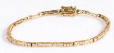 A 18 carat carat gold and diamond bracelet, with many brilliant cut diamonds all along the bracelet,