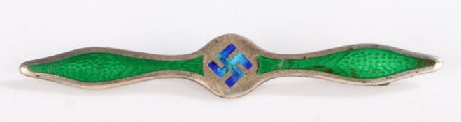 A silver and enamel bar brooch in the form of propeller, set with a swastika to the center in blue