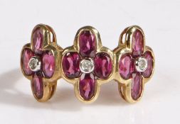 A 9 carat gold diamond and violet stone ring, the head set with three flowers heads set with four