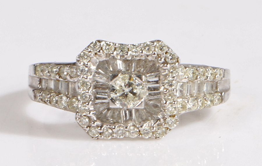 A 9 carat white gold and diamond ring, the head set with a central diamond approx 0.15 carat