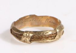 A mid 19th century unmarked gold coloured mourning ring, the ring with hair woven through out the