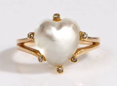A yellow metal coloured moonstone ring, the head set with a claw mounted heart shaped moonstone,