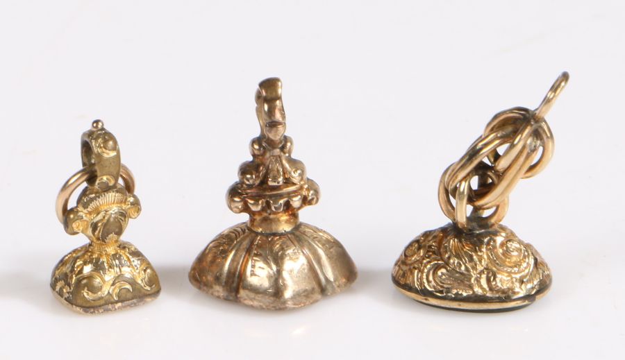 Three 19th Century yellow metal fob seals, one set with bloodstone, citrine and a clear stone