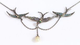 An antique silver and enamel/glass necklace formed of three swallows, each with a red gemset eye and
