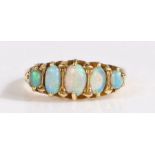 An 18 carat gold and opal ring, set with five graduated cabochon white opals in claw setting, 5.12