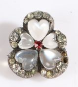 A white metal and moonstone flower brooch in the form of a pansy, having five moonstone petals