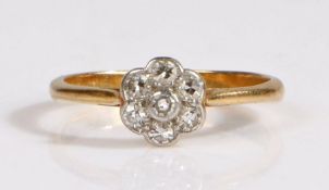 An 18 carat gold and diamond flower cluster ring, set throughout with old brilliant-cut diamonds, in