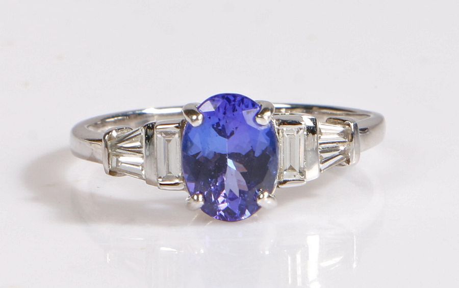 18 carat white gold and Tanzanite ring, the central oval cut tanzanite weighing 1.25 carats is
