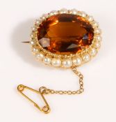 A 15 carat gold, citrine and pearl brooch, the large oval cut citrine is surrounded by a halo of