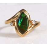 A 9 carat gold ammolite triplet and diamond ring, the head set with a elliptical ammolite triplet