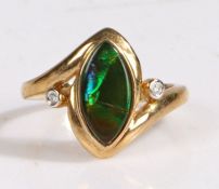 A 9 carat gold ammolite triplet and diamond ring, the head set with a elliptical ammolite triplet