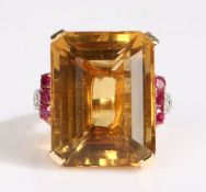 A 14 carat gold and cirtine, diamond and ruby ring, the large emerald cut citrine weighing 32 carats