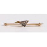 A yellow metal bar brooch decorated with a bird, the body of the bird decorated with diamonds and