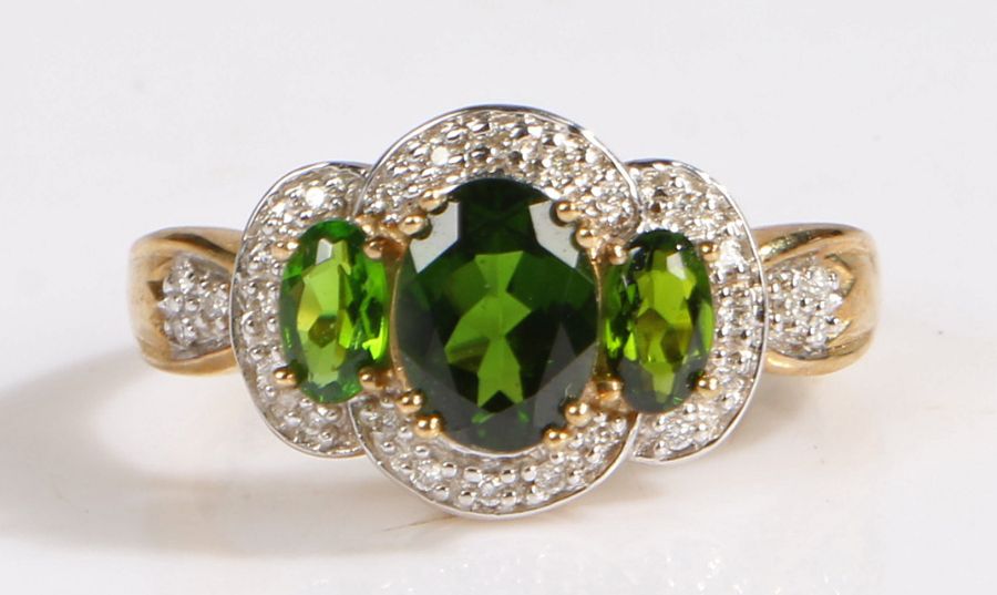 A 9 carat gold chrome diopside and diamond ring, the head set with three claw mounted chrome