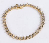 A 10 carat gold and diamond bracelet, the bracelet with illusion set diamonds with intersecting