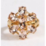 A 14 carat gold magnolia morganite ring, the head in the form of a flower set with seven claw