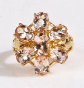 A 14 carat gold magnolia morganite ring, the head in the form of a flower set with seven claw