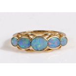 9 carat gold and five stone opal ring, having three well matched graduated oval cut opals accented