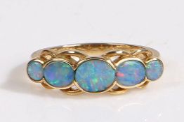 9 carat gold and five stone opal ring, having three well matched graduated oval cut opals accented