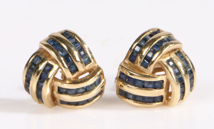A pair of 9 carat gold and sapphire earrings, with six rows of princess cut sapphires forming a