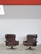 A pair of Danish leather swivel chairs, on formed laminate bases, 87cm high, 80cm wide (2)