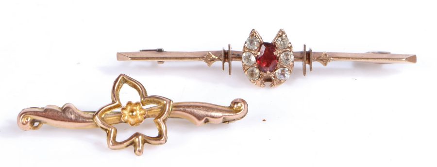 Yellow metal bar brooch decorated with a horse shoe in paste and garnet together with another yellow