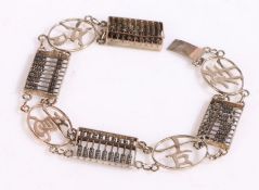 White metal bracelet with panels of Chinese characters and abacus, stamped 14k to the clasp, 19cm