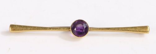 15 carat gold and amethyst bar brooch, set with a round cut amethyst, 6.5cm long weight 2.9 grams