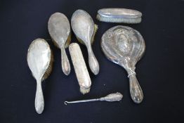 Silver handled dressing table accessories, various dates and makers, to include hand mirror, three