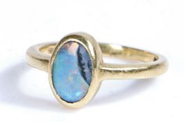 A 18 carat gold and opal ring, the head set with a oval opal AF, ring size R weight 5.1 grams