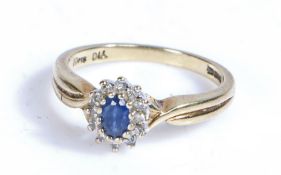 9 carat gold sapphire and diamond ring, the head set with a claw mounted oval cut sapphire