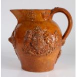 19th Century pottery Patent jug, the honey glaze with crowns and flowers to the rim above the