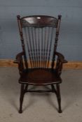 20th century arts and crafts style oak Windsor chair, with a floral carved cresting rail above