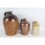 Three stoneware jugs, one marked Wolton & Attwood Colchester, the largest 36cm high