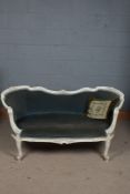 A 20th century French white painted settee/sofa, having a floral carved back rail above a light blue