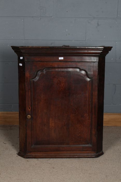 A George III oak corner hanging cupboard, with a moulded cornice above a single door opening to - Image 2 of 2