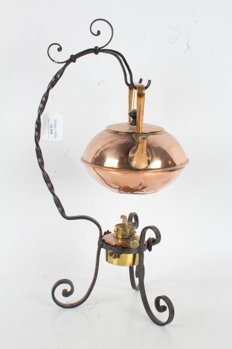 W.A.S. Benson style tea kettle and stand, the copper kettle with angular handle, on a scrolled