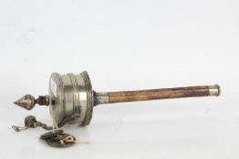 Chinese white metal prayer wheel together with some coins, 30cm long