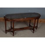 20th century mahogany coffee table, with a cane and glass top set on a carved frieze and reeded