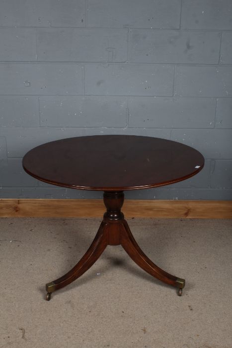 A Victorian mahogany tilt top breakfast table, the circular top above a turned baluster column