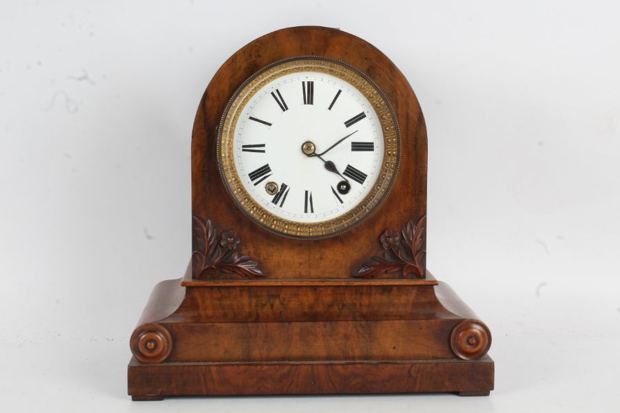 Winterhalder and Hofmeier walnut cased mantel clock, the arched case with roundel decorated plinth